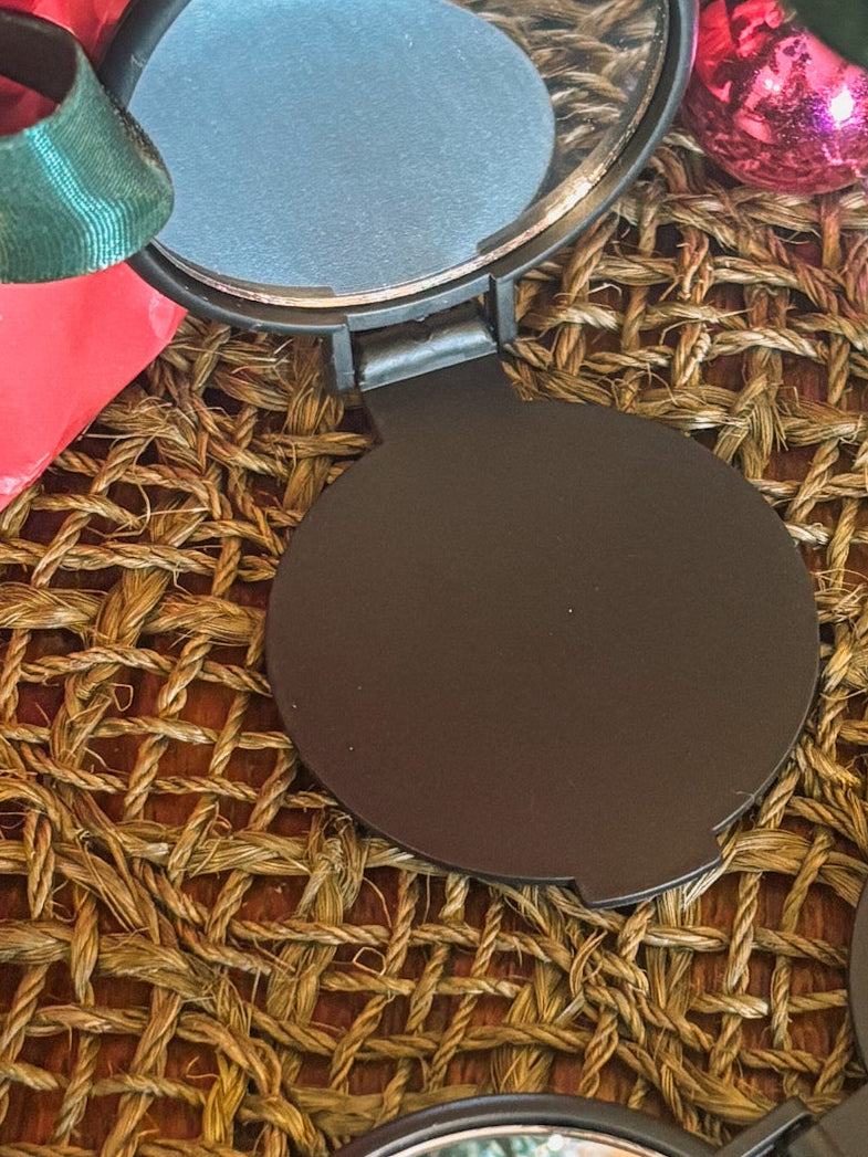 Compact mirror with a reflective surface on a textured woven surface