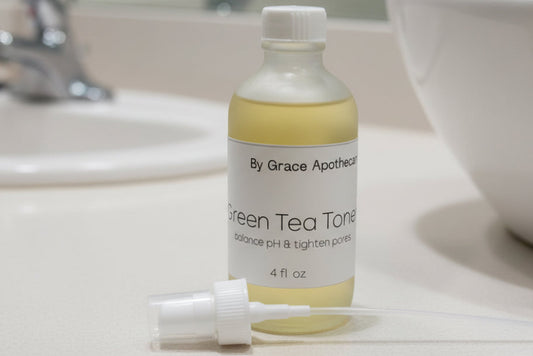 Bottle of toner by Grace Apothecary on a metallic surface